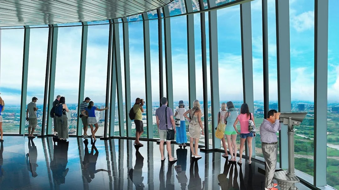 Visitors enjoying panoramic views from Saigon Skydeck in Bitexco Financial Tower.
