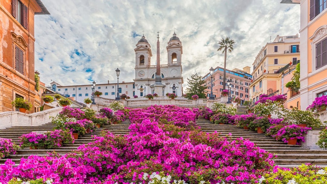 Spanish Steps in Rome adorned with vibrant pink flowers.