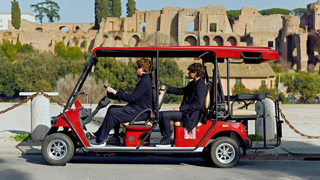 Golf cart tour near ancient ruins in Rome.