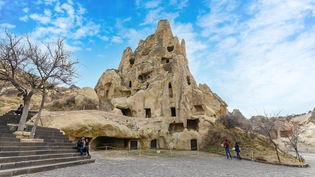 Rock-cut churches at Goreme Open Air Museum, Cappadocia, with visitors exploring the site.