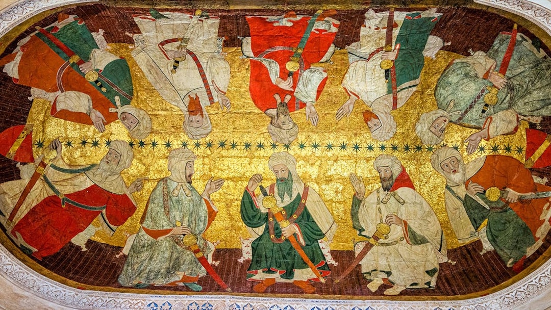 Alhambra ceiling artwork depicting historical figures in traditional attire.