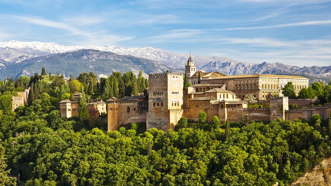 Alhambra palace complex with Sierra Nevada mountains in Granada, Spain.