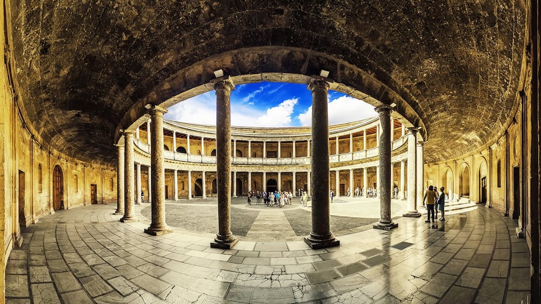 Alhambra's circular courtyard with tourists exploring, Granada, Spain.