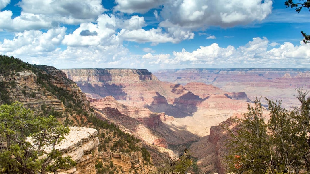 Grand Canyon view with layered rock formations under a cloudy sky, part of Hummer tour experience.