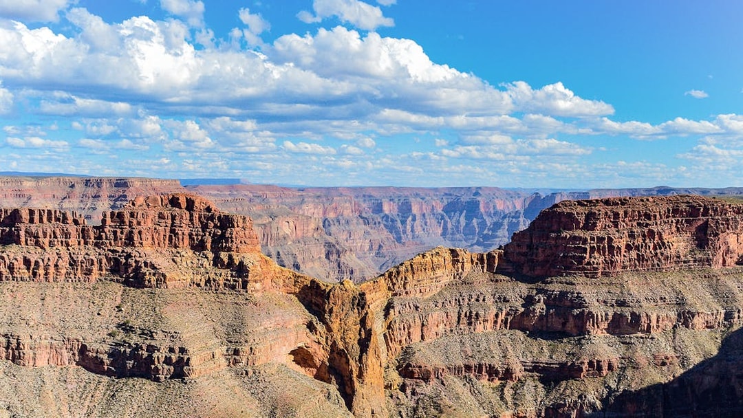 Grand Canyon Eagle Point with layered rock formations under a blue sky.