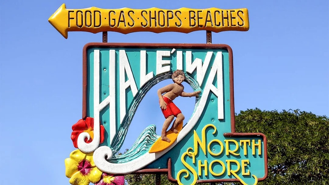 Haleiwa Town sign with surfer and North Shore text, Oahu, Hawaii.