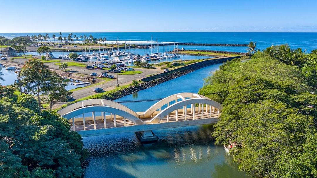 Aerial view of Haleiwa Bridge and marina on Oahu's Grand Circle Island tour.