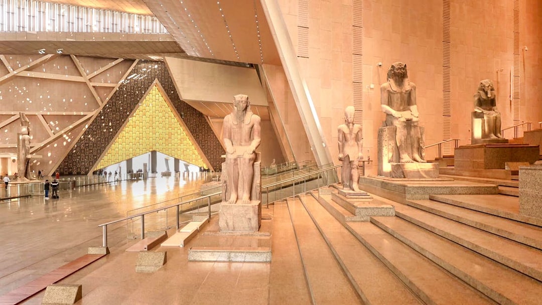 Grand Egyptian Museum interior with ancient statues and architectural design.