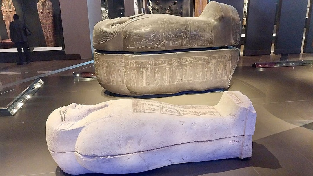 Ancient Egyptian sarcophagi displayed at the Grand Egyptian Museum.
