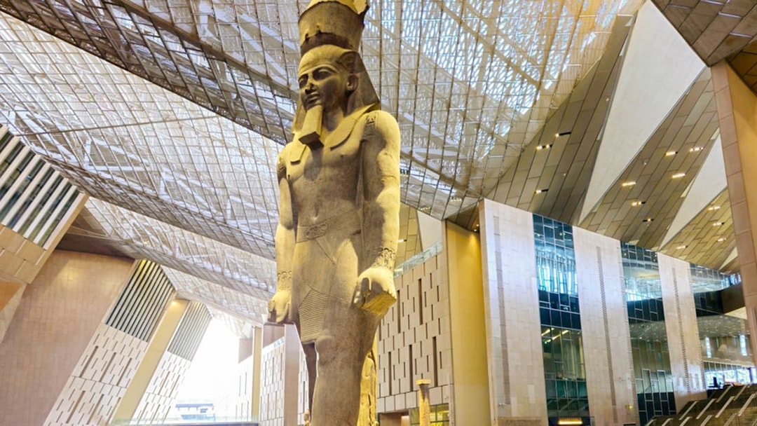 Grand Egyptian Museum interior with large pharaoh statue, Cairo.
