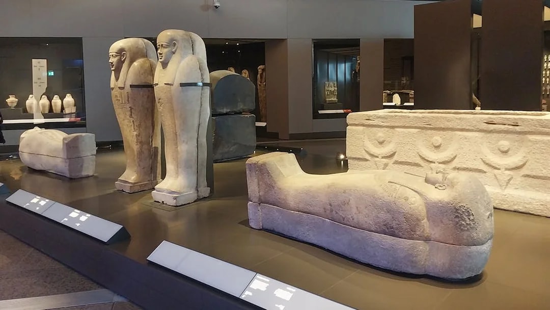 Ancient Egyptian sarcophagi displayed at the Grand Egyptian Museum.
