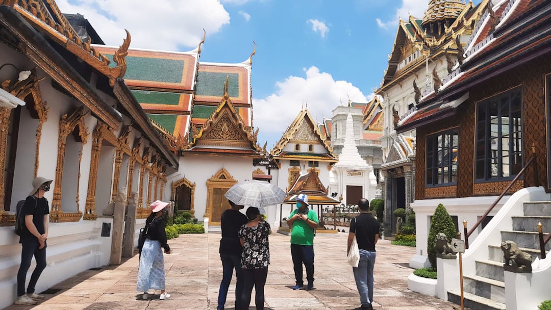 Visitors exploring ornate architecture at Grand Palace, Bangkok during Wat Phra Kaew walking tour.