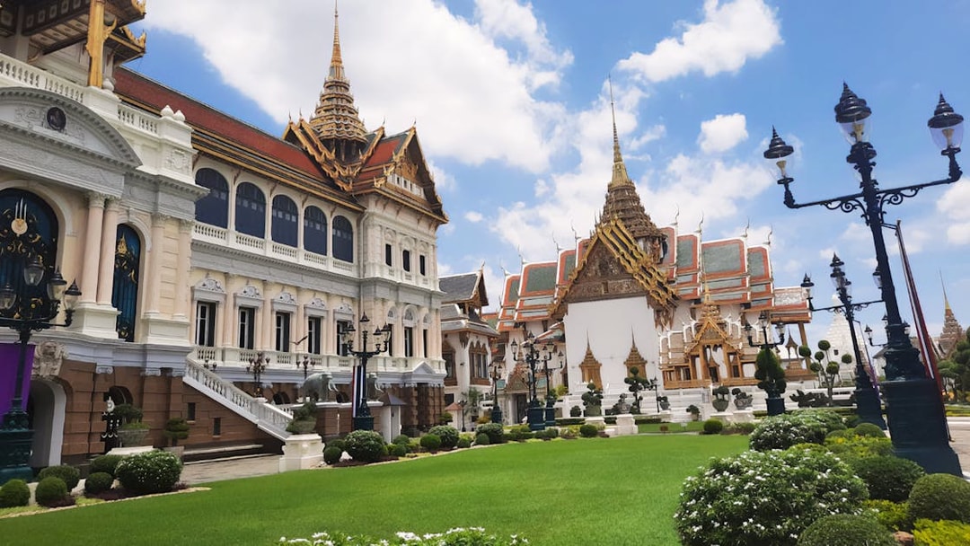 Grand Palace and Wat Phra Kaew buildings with ornate roofs in Bangkok, Thailand.