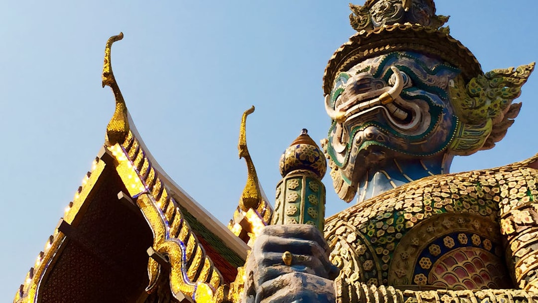 Giant guardian statue at Wat Phra Kaew, Bangkok, during Grand Palace walking tour.