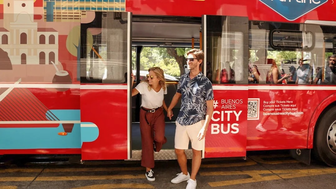 Couple exiting Buenos Aires hop-on hop-off City Bus Gray Line.