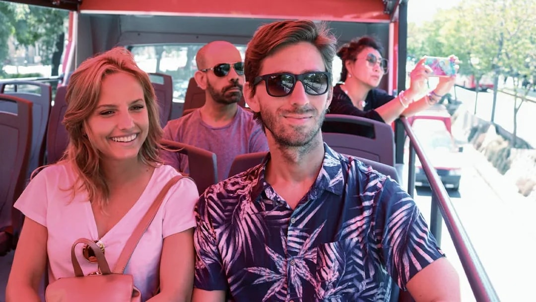 Couple enjoying a Buenos Aires hop-on hop-off tour bus ride.