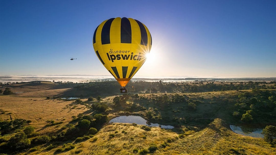 Hot air balloon over Ipswich landscape during Greater Brisbane flight.