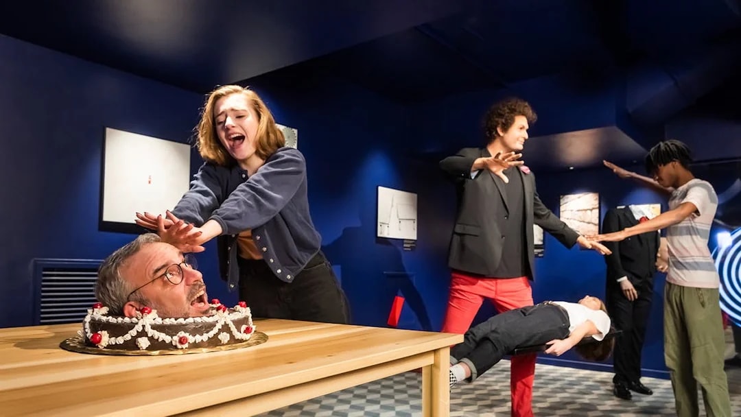 Visitors interacting with wax figures at Grévin Paris Wax Museum.