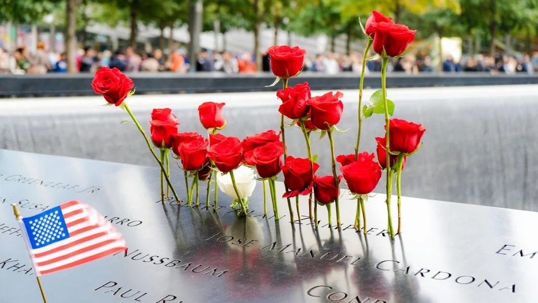 Red roses and an American flag at the National September 11 Memorial in New York City.