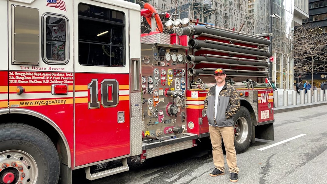 FDNY Engine 10 parked on a New York City street with a person standing beside it.