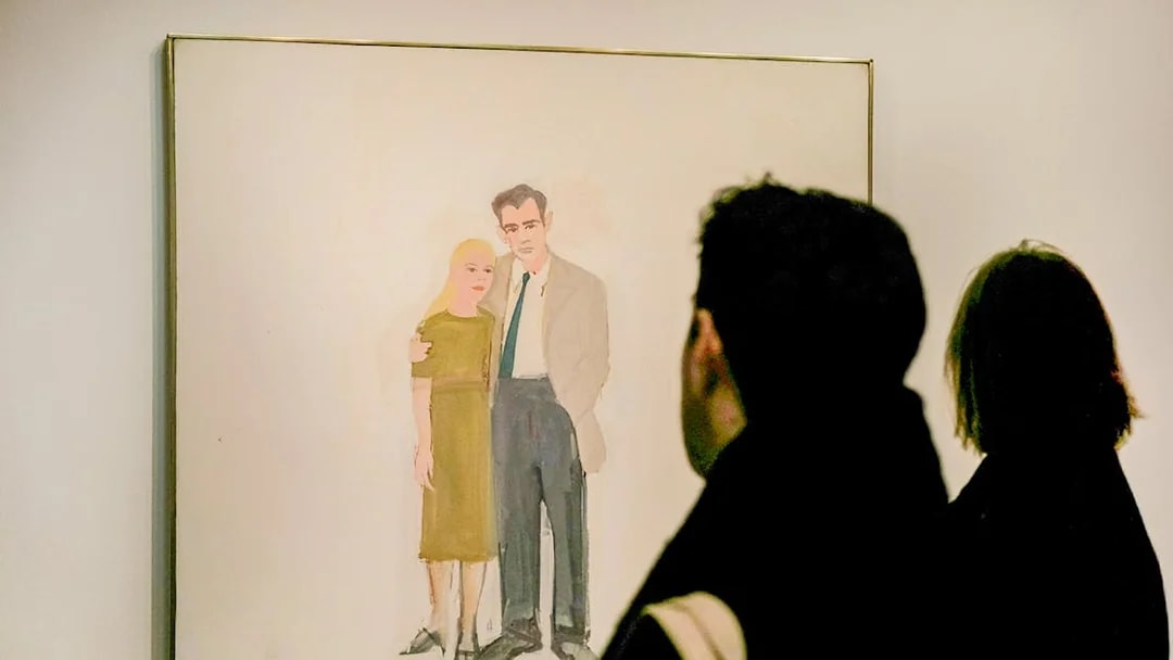 Visitors viewing a painting at the Guggenheim Museum, New York.