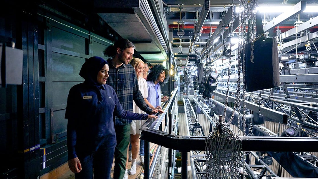Visitors explore backstage mechanics on Sydney Opera House guided tour.
