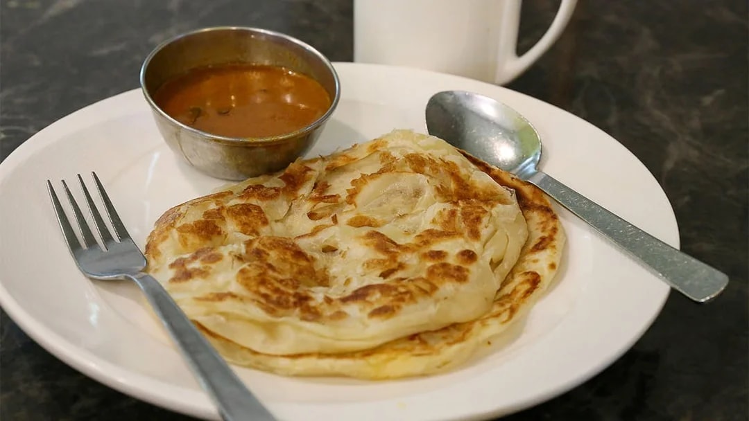 Plate with paratha and curry served on the Bike and Bites Food Tour.