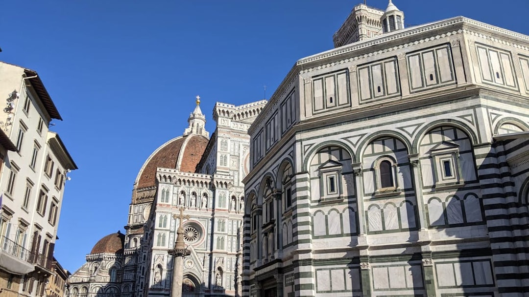 Florence's Duomo Square with Cathedral and Baptistery under clear sky.