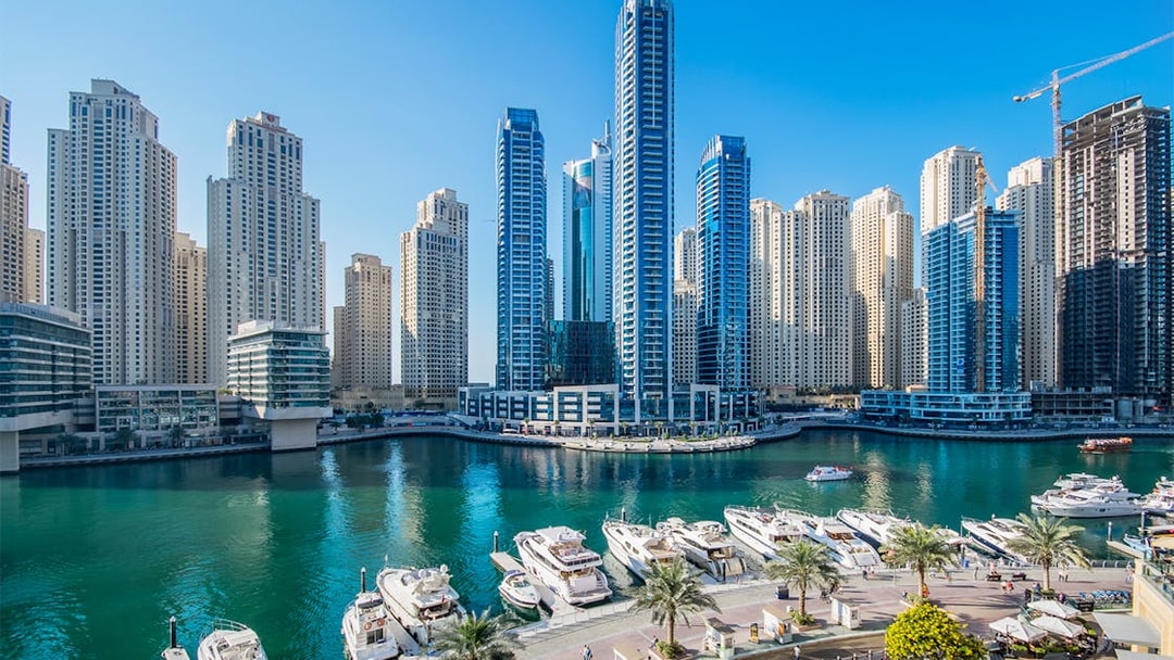 Dubai Marina skyline with yachts docked, seen during a guided boat tour.