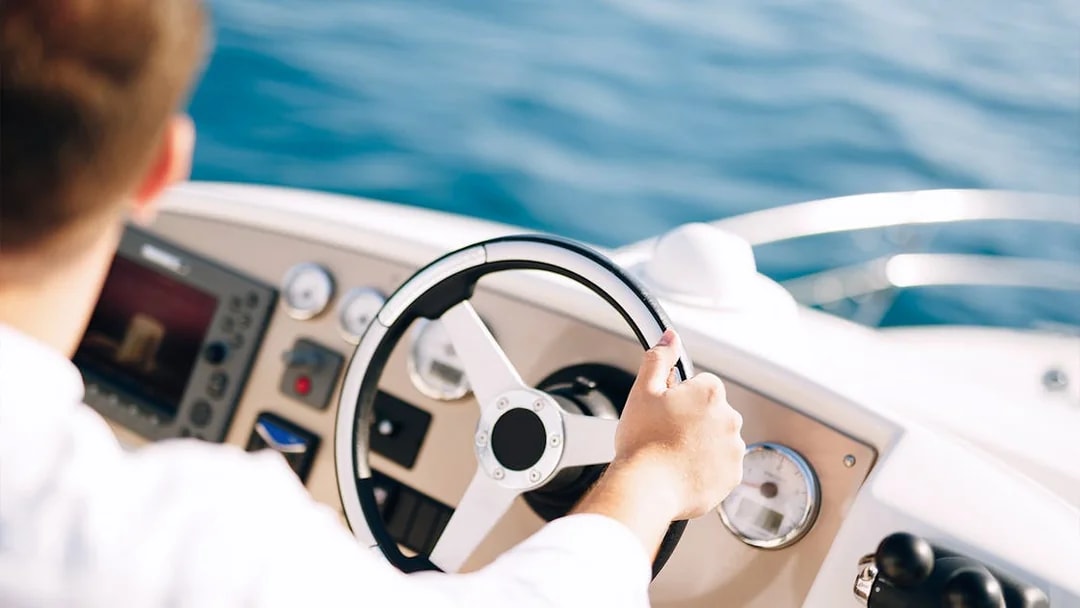 Steering a boat on a guided tour in Dubai.