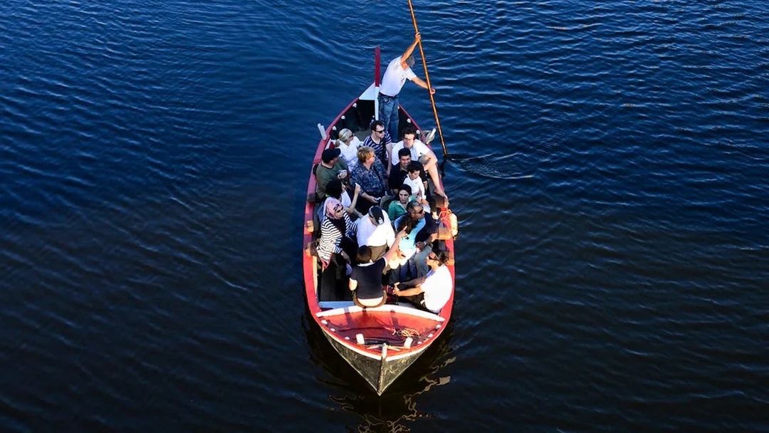 Group enjoying a guided boat tour on a Florentine gondola.