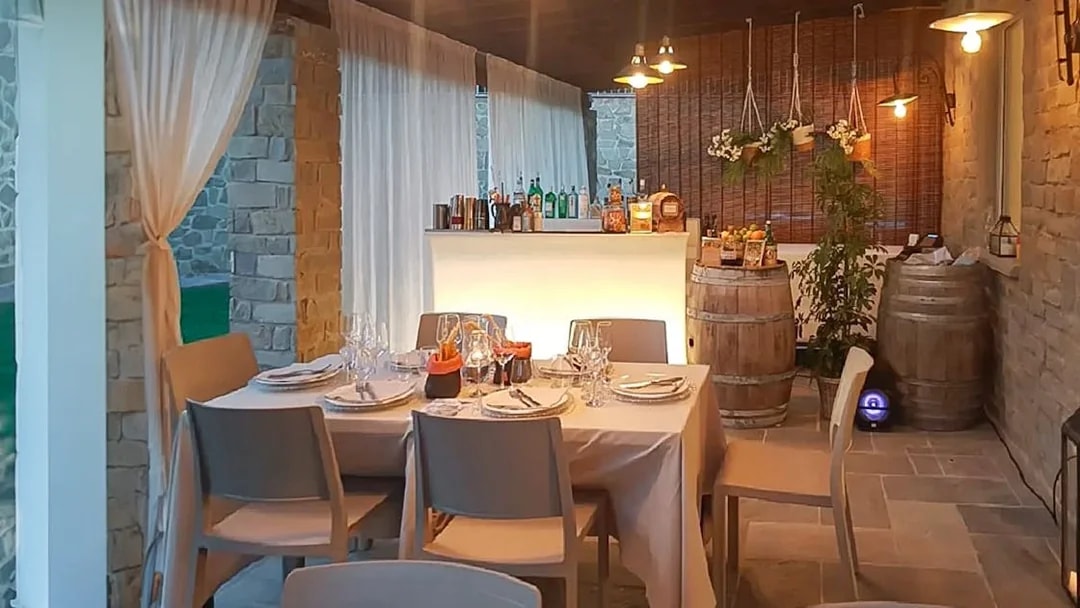 Dinner setup in a rustic Chianti setting with wine barrels and a bar, part of the eBike tour experience.