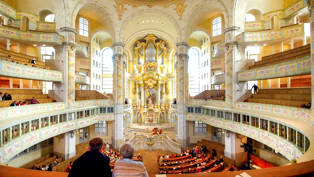 Interior view of Frauenkirche's ornate gallery during a guided tour in Dresden, Germany.