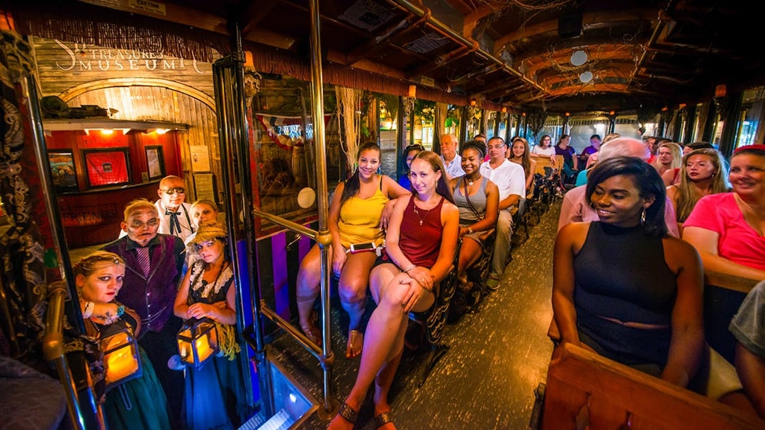 Tour group on Savannah's 'Ghosts & Gravestones' trolley with costumed guides.