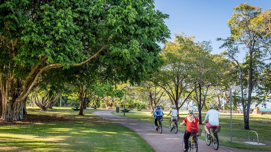 Cyclists on a scenic path during a guided half-day city tour of Darwin.