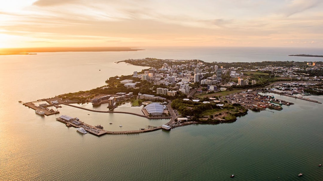 Aerial view of Darwin cityscape and coastline during sunset, Northern Territory, Australia.