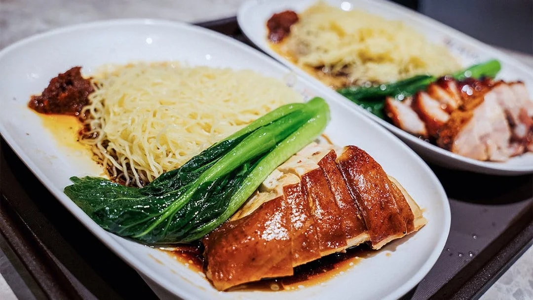 Noodles with roasted chicken and greens at a Michelin-starred restaurant.