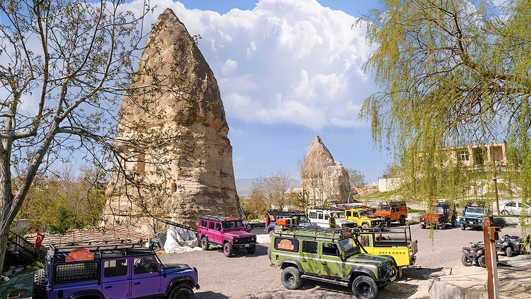 Jeep convoy parked near rock formations in Cappadocia during guided off-road tour.