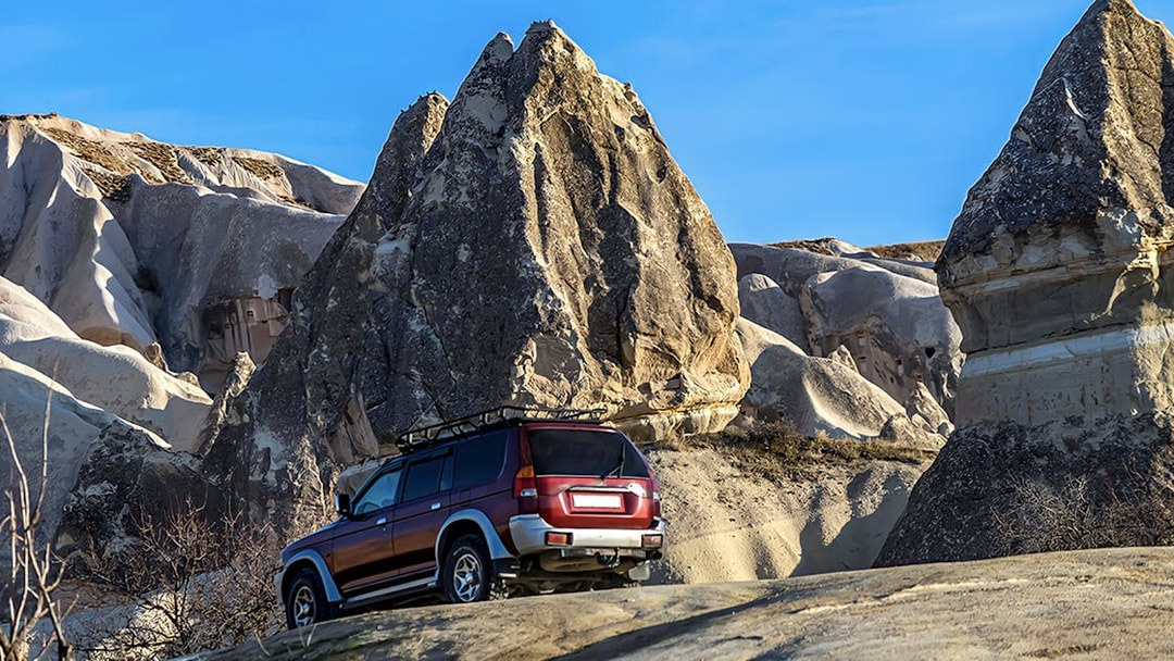Off-road jeep navigating rocky terrain in Cappadocia during guided tour.