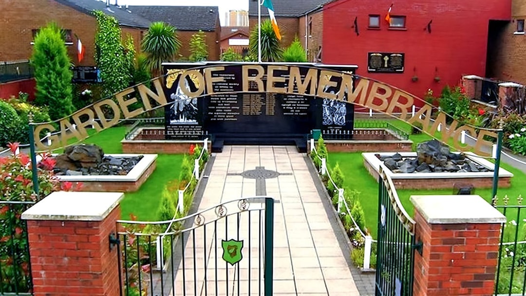 Garden of Remembrance entrance in Belfast, featuring memorial plaques and lush greenery.