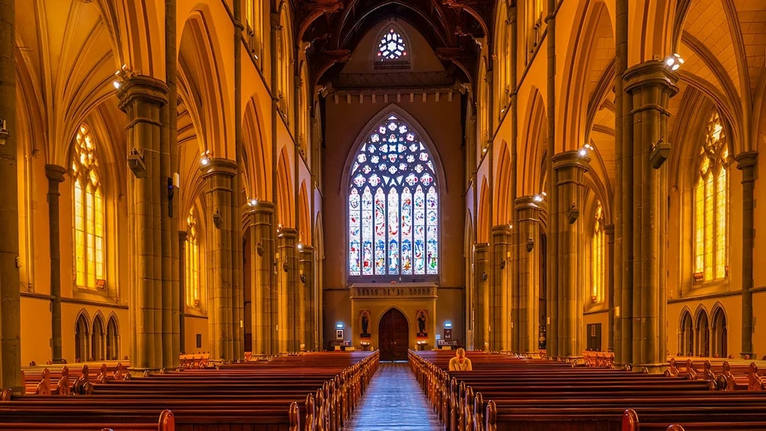 Stained glass window and arches inside St Patrick's Cathedral, Melbourne.