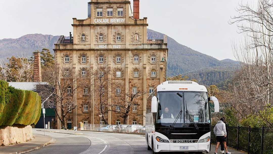 Bus parked near Cascade Brewery with Mt Wellington in the background.