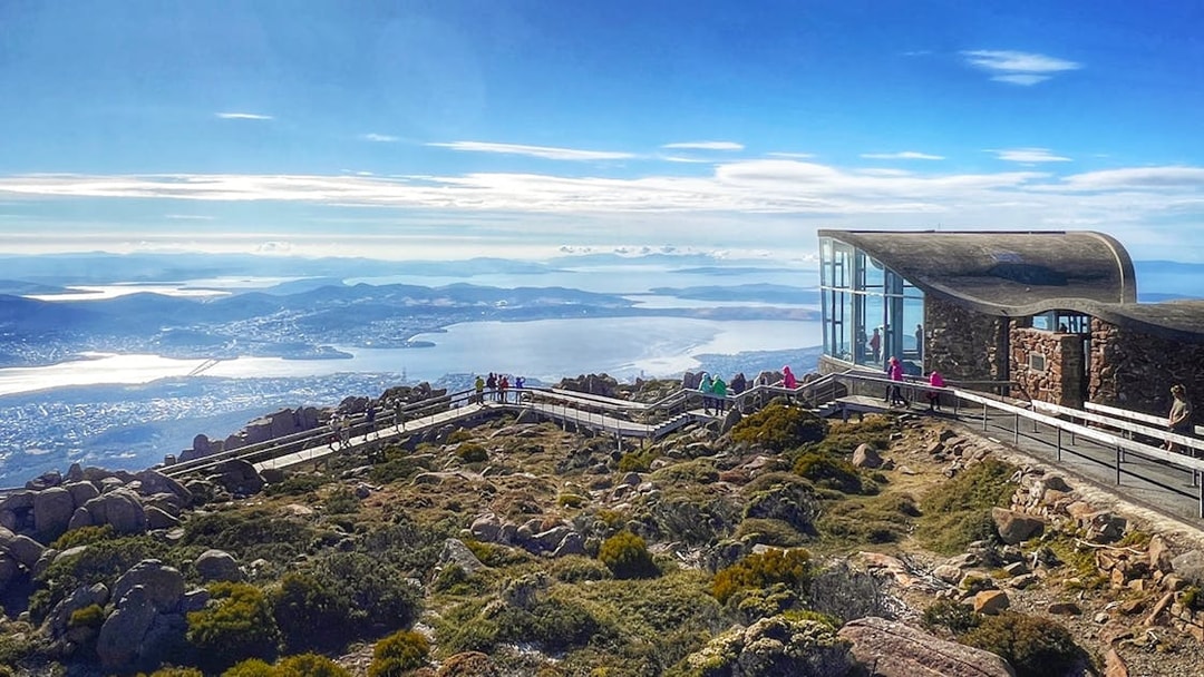 Visitors walking on the boardwalk at Mt Wellington summit, overlooking Hobart, Tasmania.