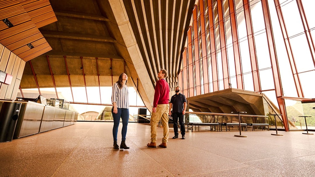 Visitors on a guided tour inside the Sydney Opera House, admiring the architecture.