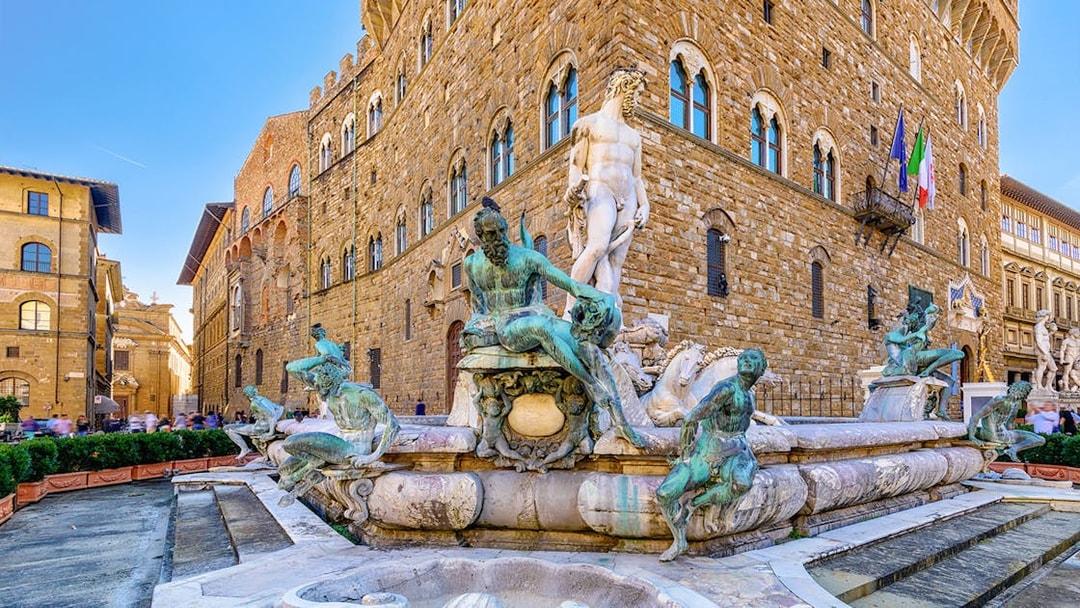 Neptune Fountain and Michelangelo's David in Piazza della Signoria, Florence, with Palazzo Vecchio.