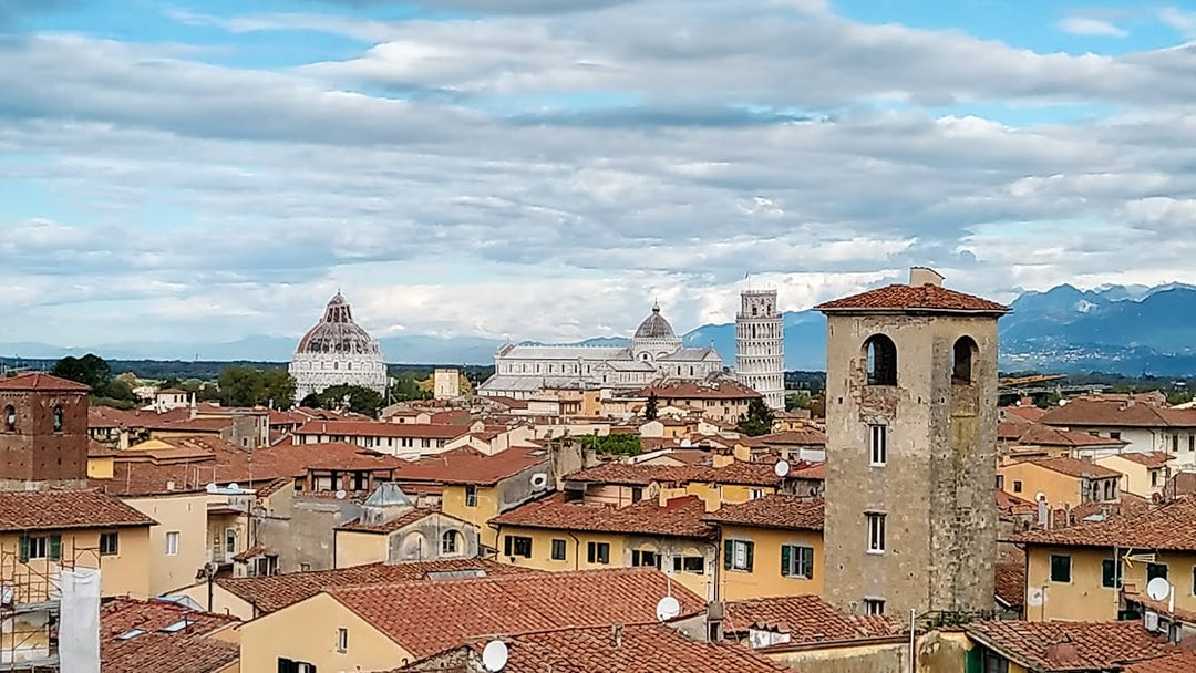 Pisa cityscape with the Leaning Tower and Cathedral in the background.