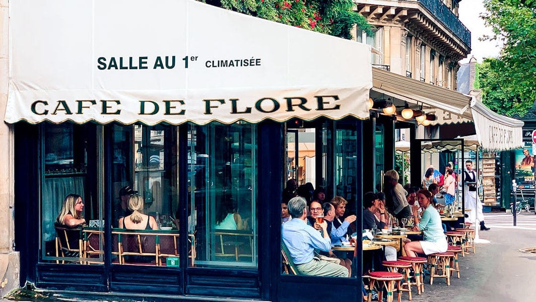 Cafe de Flore Paris, outdoor seating with people dining and conversing.