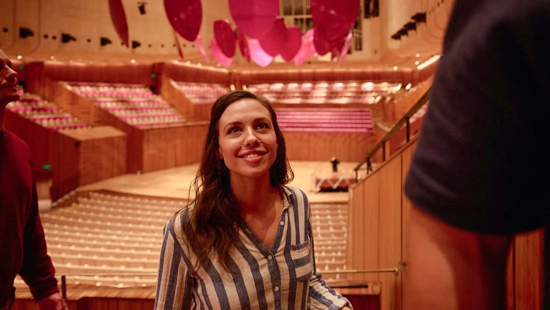 Visitor exploring the interior of Sydney Opera House during a guided walking tour.