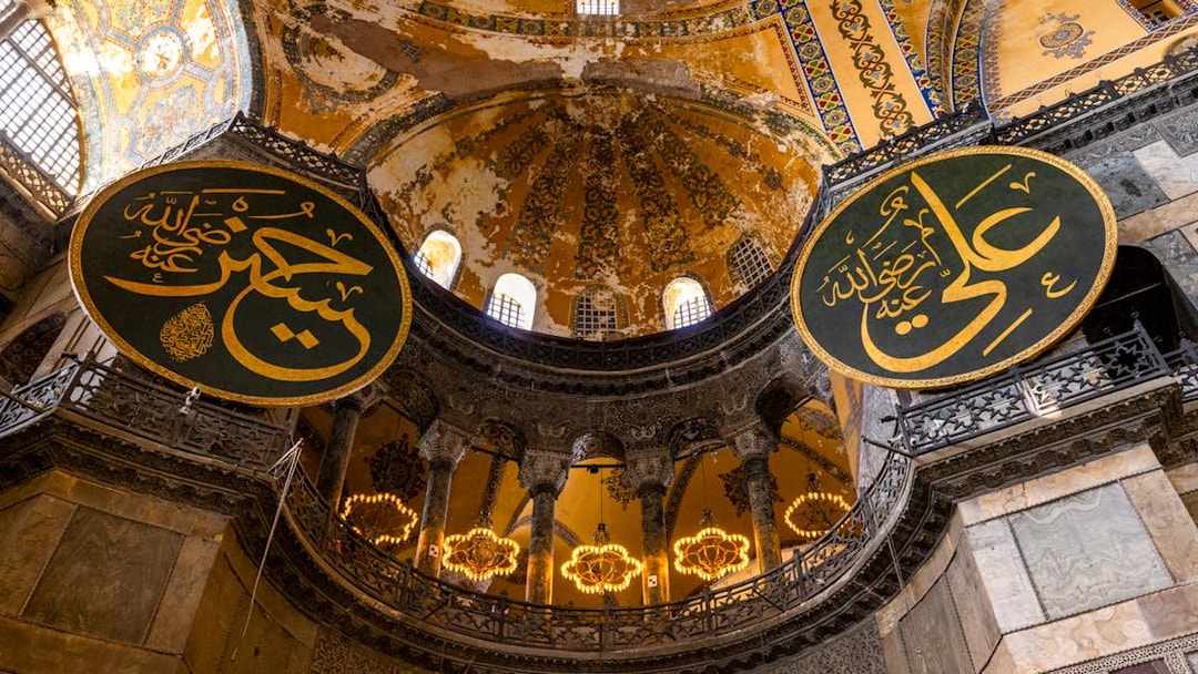 Hagia Sophia interior with Arabic calligraphy and ornate dome, Istanbul.