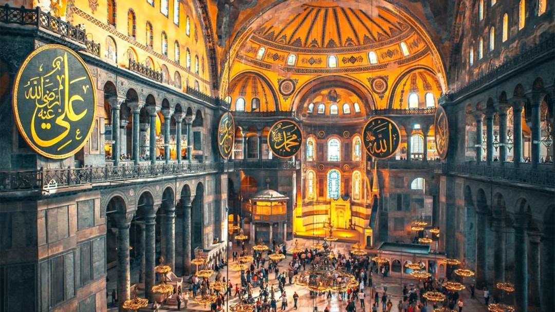 Interior view of Hagia Sophia with visitors exploring the historic architecture in Istanbul.